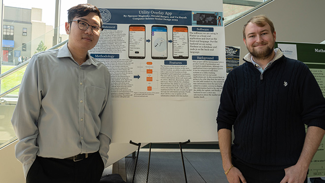 Two Computer Science majors with their poster at SASH