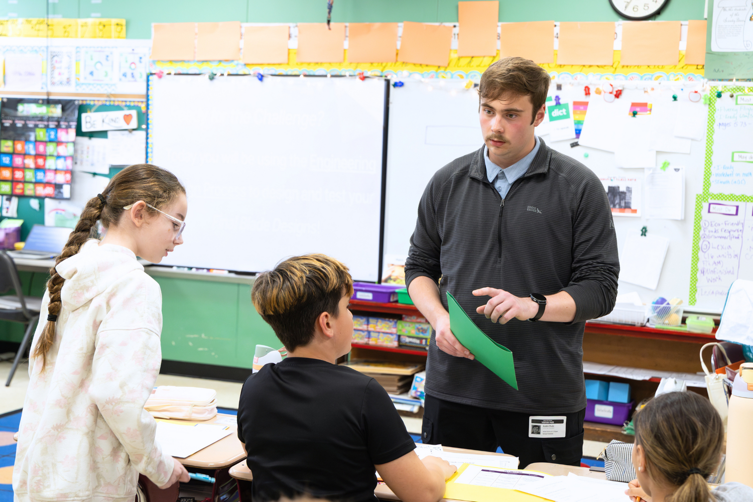 Junior Austin Wade guides fourth graders through a KidWind lesson on wind energy and engineering design.