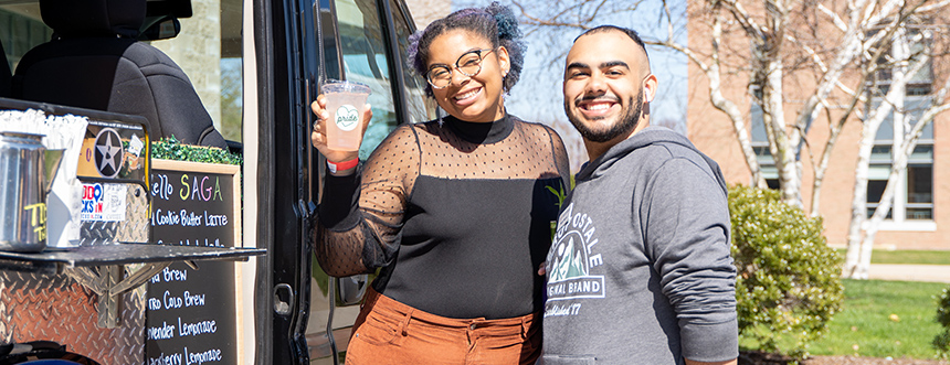 Students buy drinks from a coffee truck at a pride event