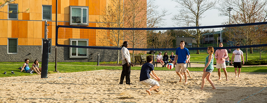 Students play volleyball on campus