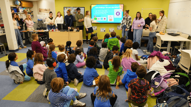 Roger Williams University preservice teachers lead second graders from The Croft School through a hands-on coding lesson.