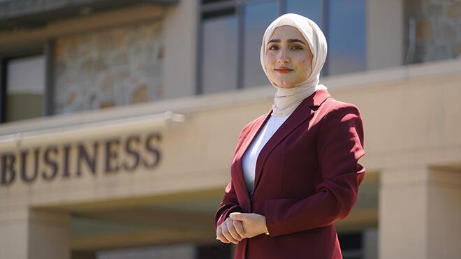 Abida Mohammady stands outside of the Mario J. Gabelli School of Business.