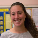 A headshot of Meghan Curran in a middle school classroom