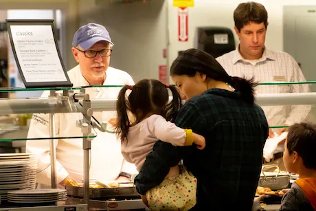 RWU member serving food to coast guard family