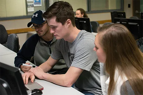 Students working at a computer.