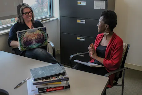 Two faculty members have a discussion.