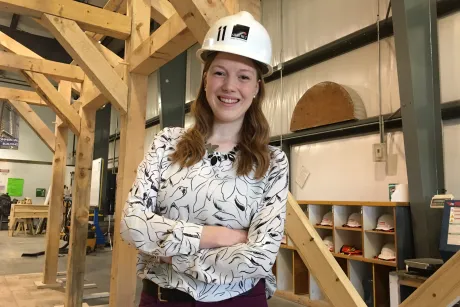 Graduate stands inside university fabrication facility