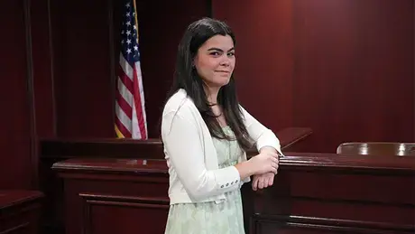 Olivia DaSilva standing in a trial room in RWU's Law School.