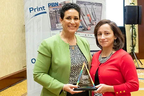 Lorraine Lalli and Zoila Quezada accept the award.