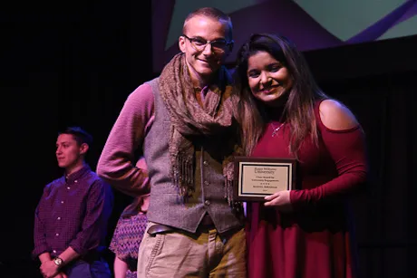 Student and staff member pose with award.