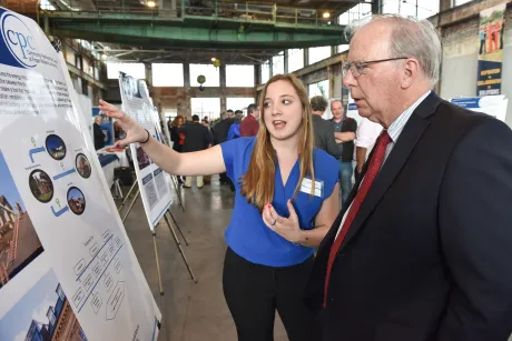 A student explains her research to a professor.