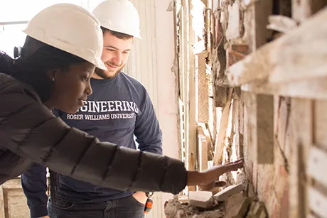 Engineering students inspect a structure.