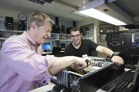 Professor and student building computer.