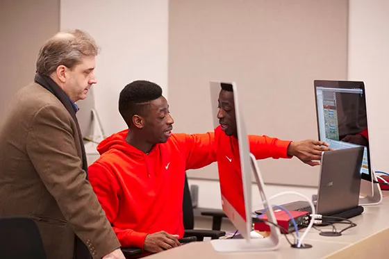 Student and professor discussing project.