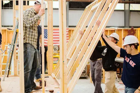 image of Construction Management students erecting a structure in wood