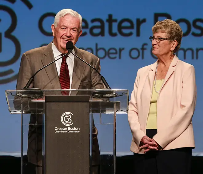 Bill Cummings speaking at podium with Joyce Cummings of Cummings Foundation