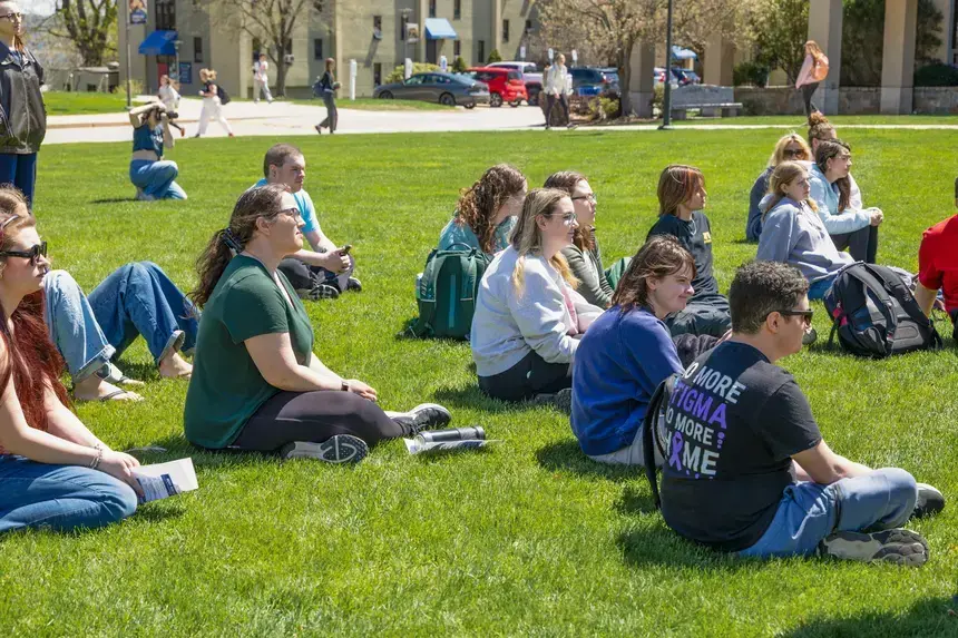 Students sitting on the grass.