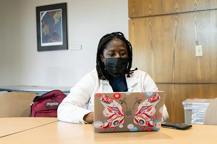 MSU treasurer Erica Prempeh works on her laptop at an e-board meeting.