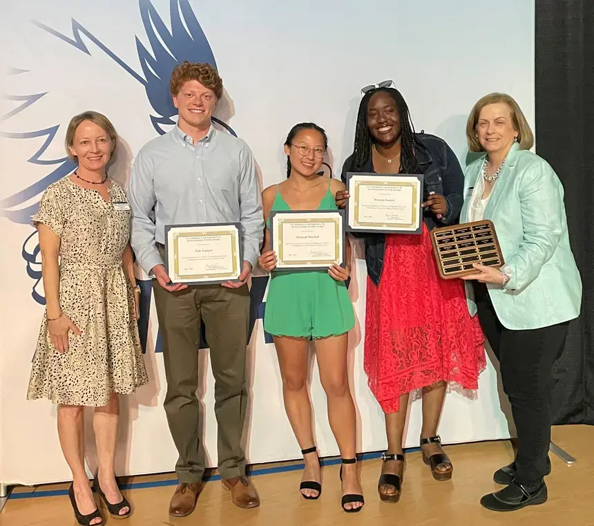 Henderson Outstanding Tutors for 2023 pose inside holding certificates