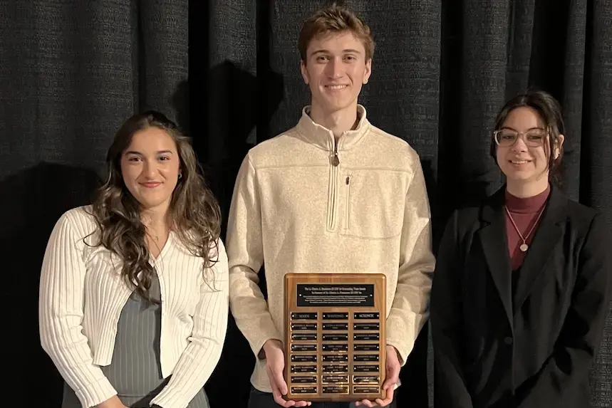 Henderson Outstanding Tutors for 2026 pose inside holding plaque