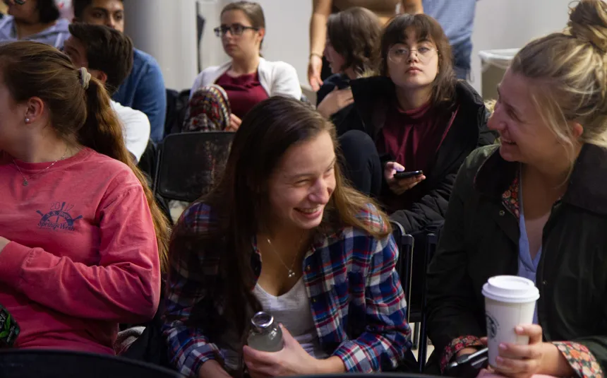 Audience members smiling.