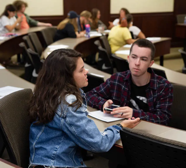 Two students engage in a discussion.