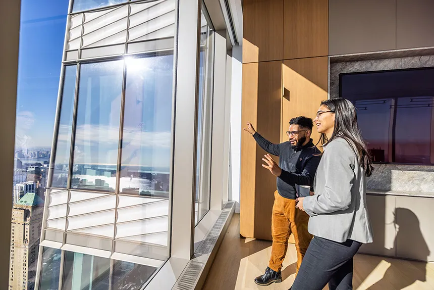 Students talk as they look out a window in NYC