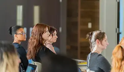 A group of Women in Business members listening to a talk.
