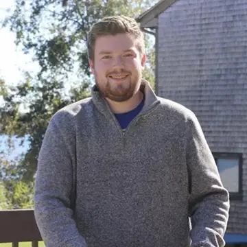 A photo of student Sean Nugent standing outside